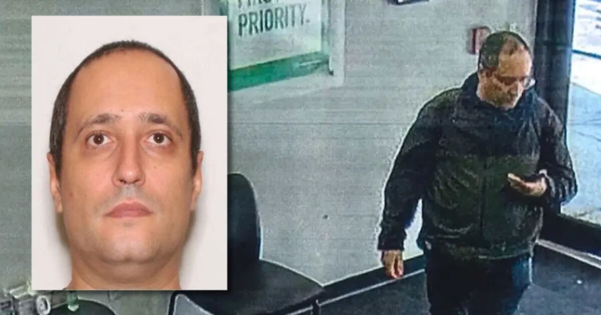 Surveillance image of a man in a dark jacket looking at his phone inside a building, with a close-up photo inset for identification purposes.